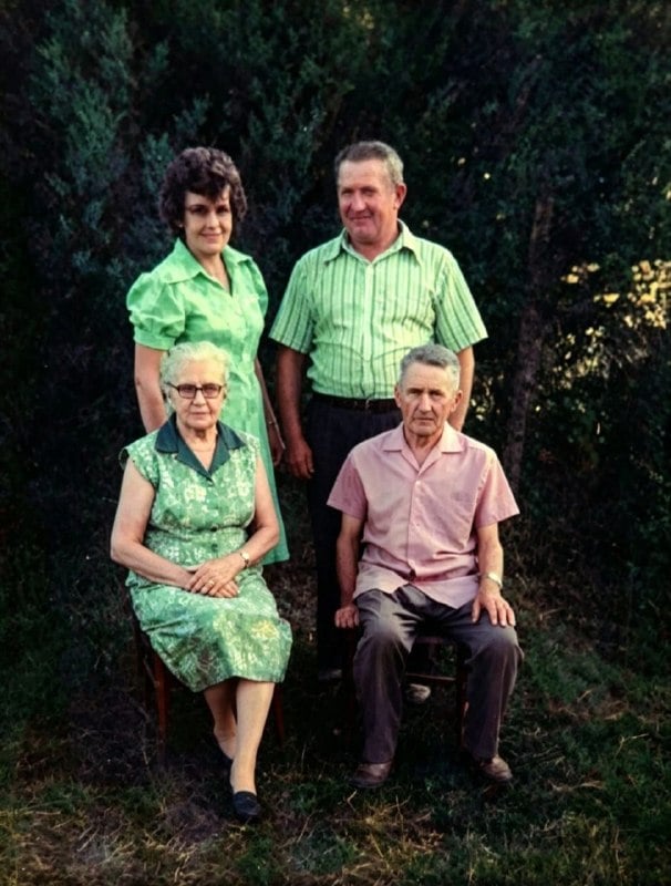 Foto familiar de los años 70: dos mujeres y dos hombres posan al aire libre, frente a un seto.